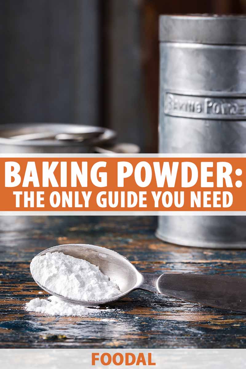Vertical image of a teaspoon of a dry leavening agent on a wooden table, with text in the middle and on the bottom of the image.