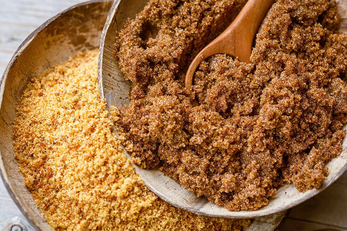 Horizontal image of two bowls filled with different dried varieties of sweeteners.