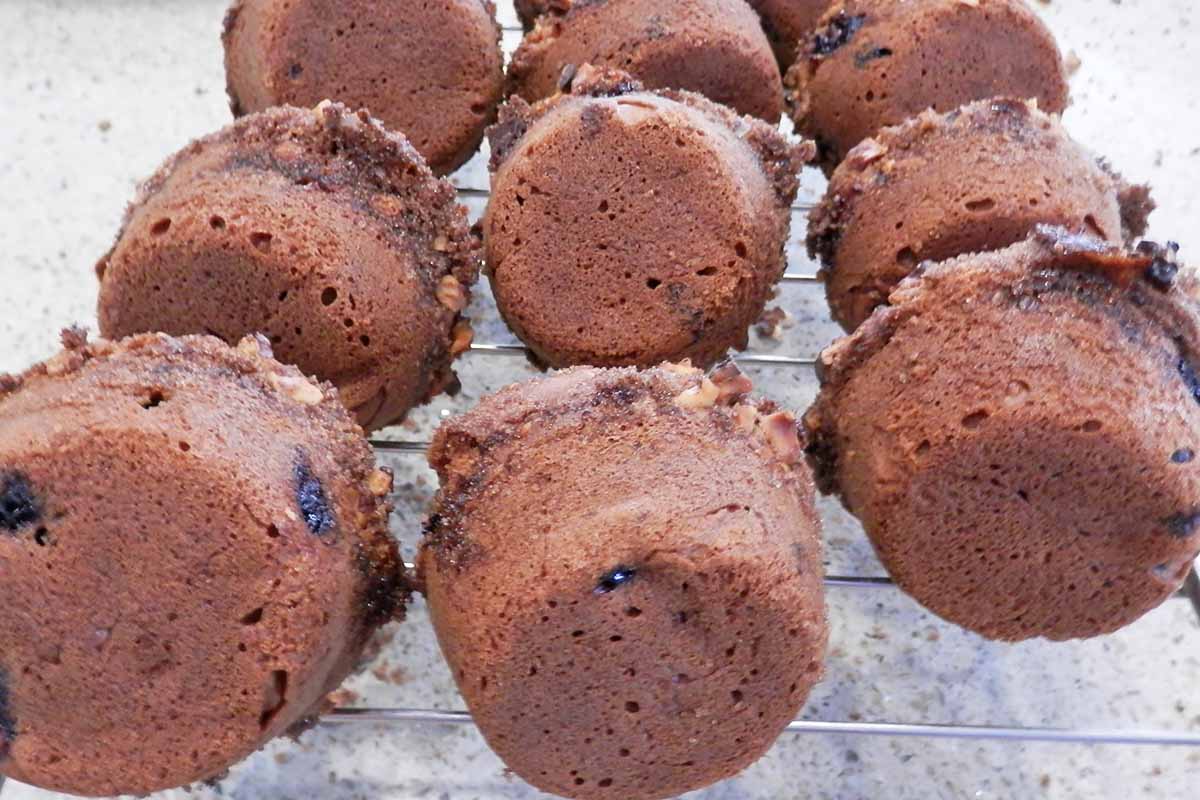 Image of the bottoms of blueberry pastries cooling on a cooling rack.