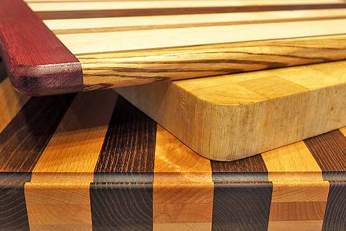 Three wooden cutting boards stacked up on each other | Foodal