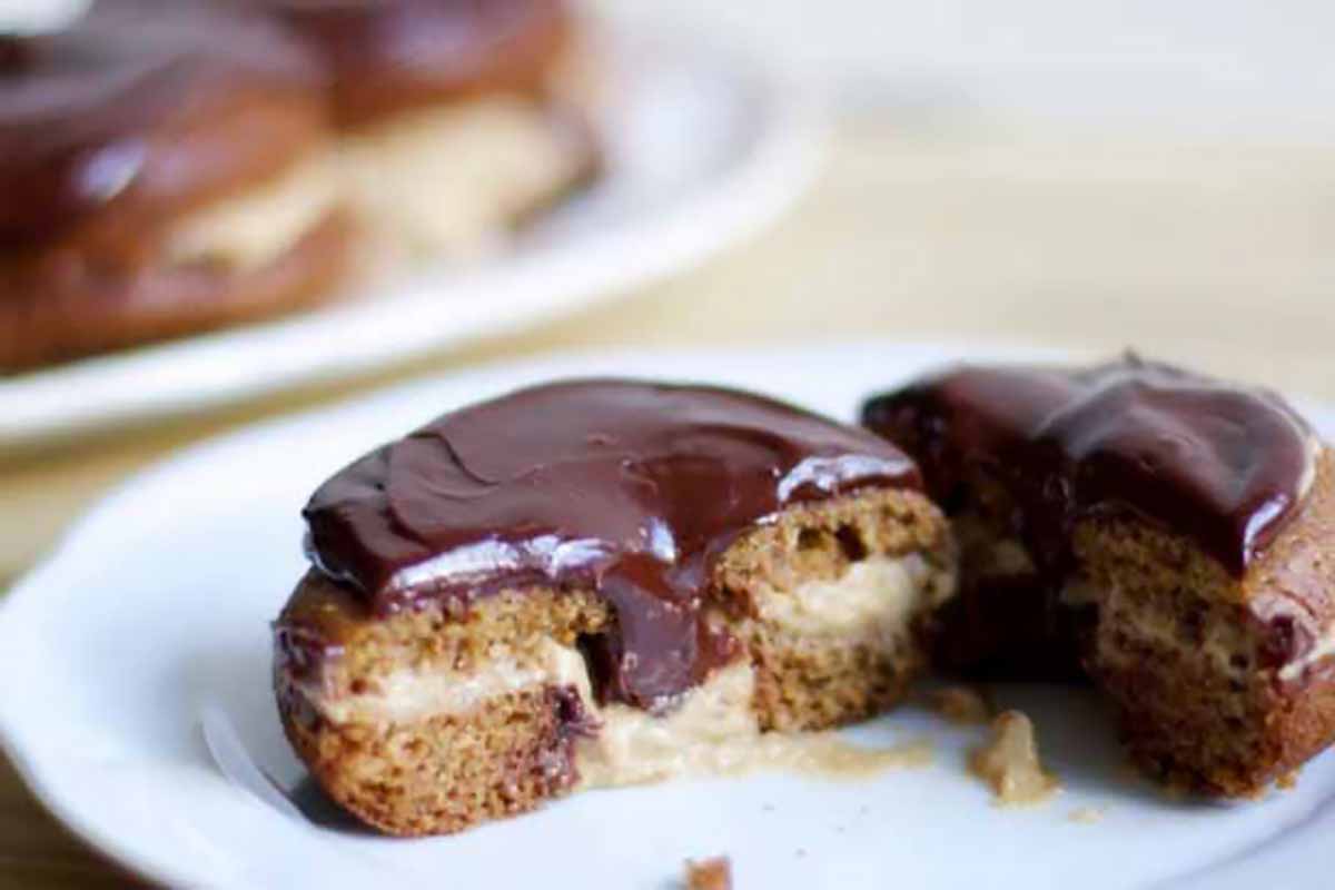 Horizontal image of a Boston cream doughnut with thick glaze.