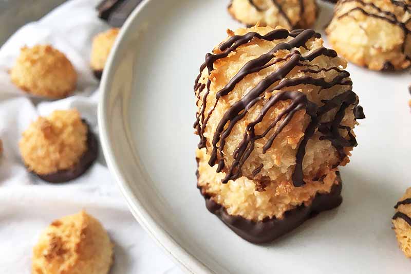 Horizontal image of stacked macaroons with dark chocolate.