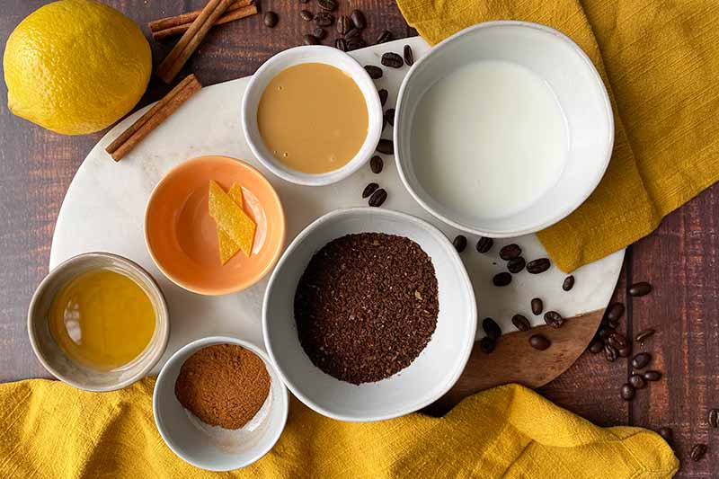 Horizontal image of assorted ingredients measured in bowls.