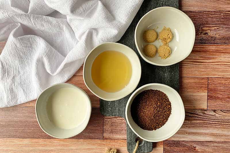 Horizontal image of prepped ingredients in small white bowls.