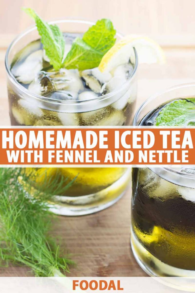 Vertical image of two glasses filled with a dark green clear liquid topped with ice, mint, and lemon wedges on a wooden surface next to green fronds, with text in the middle and on the bottom of the image.