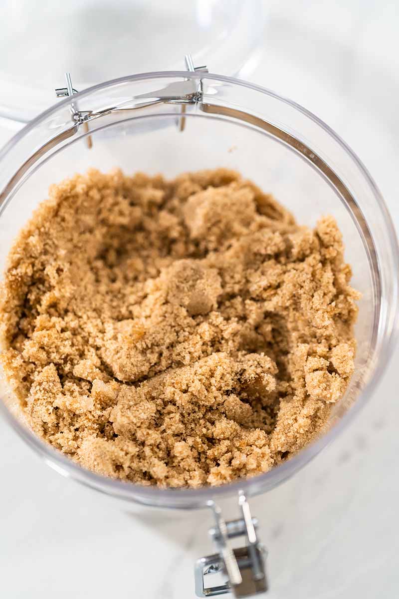 Vertical image of a glass jar filled with brown sugar.