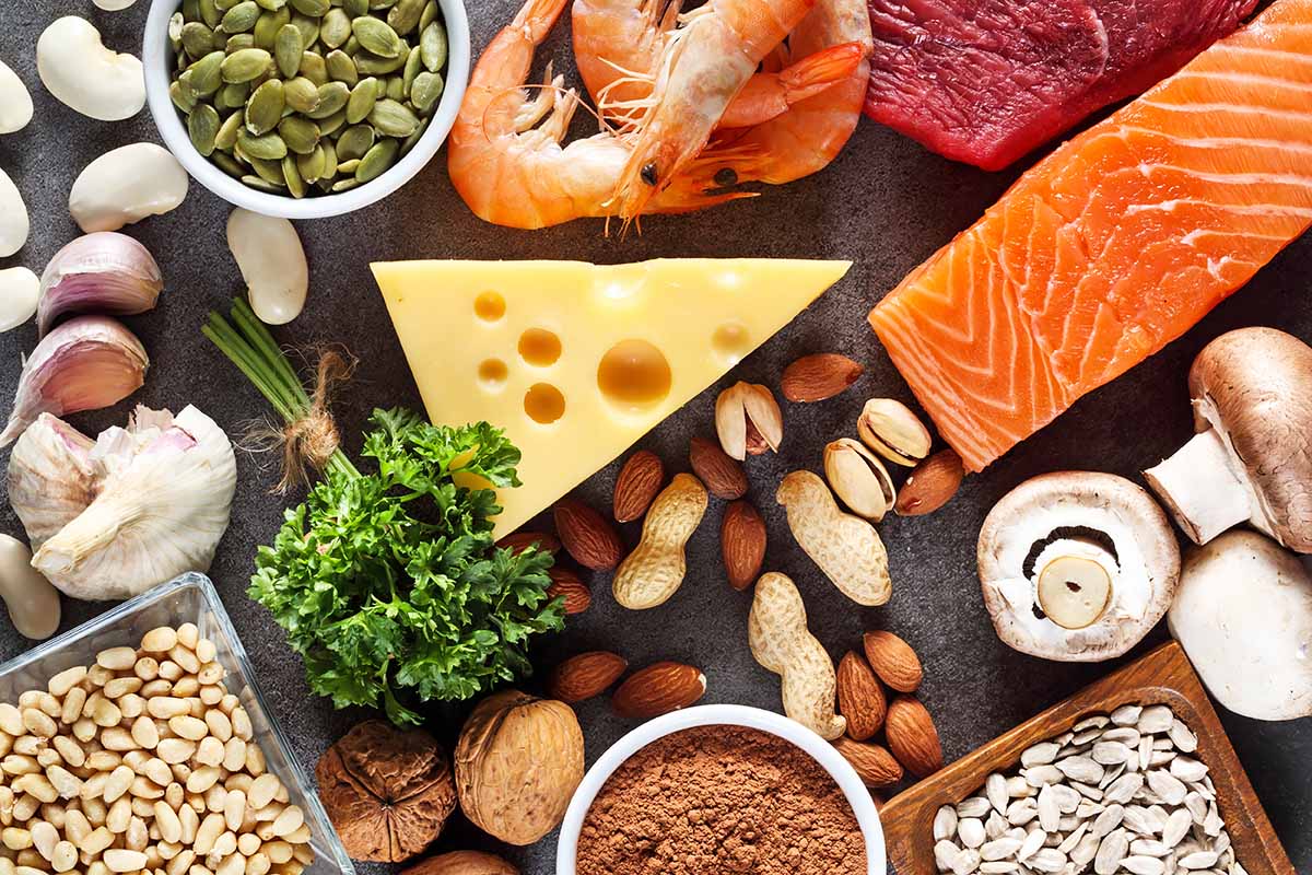 Horizontal image of a display of assorted healthy and fresh foods on a slate display.