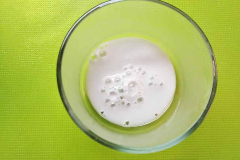 Horizontal image of testing the strength of leavening agents in a bowl with water.
