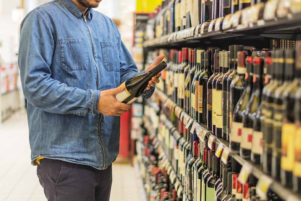 Horizontal image of a man buying drinks at a store.