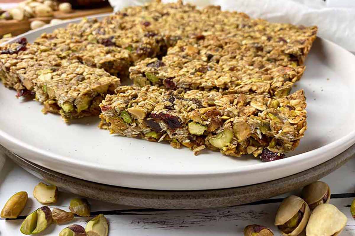 Horizontal image of pistachio granola bars on a large white plate.