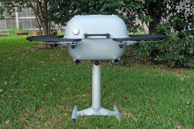 A Silver PK Grill 360 in a backyard setting.