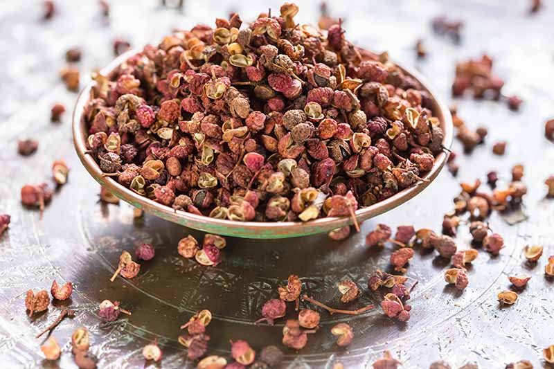Horizontal image of a bowlful of whole spices.
