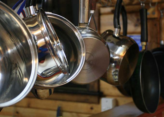 Various types of cookware hanging from ceiling